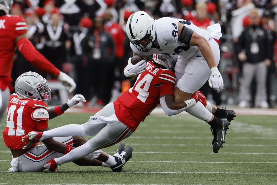 Ohio State defensive back Jermaine Mathews, left, tackles Penn State tight end Theo Johnson during the second half of an NCAA college football game Saturday, Oct. 21, 2023, in Columbus, Ohio. (AP Photo/Jay LaPrete)