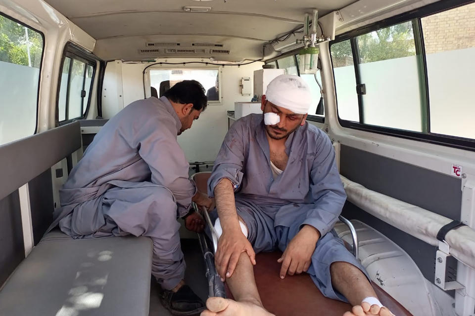 A man, who was injured at a bombing, sits in an ambulance as he arrived at a hospital, in Sibi, a district in the Pakistan's Baluchistan province, Monday, March 6, 2023. A suicide bomber riding on a motorcycle rammed into a police truck in Pakistan's restive southwest, killing and wounding police officers in one of the deadliest attacks on security forces in recent months, authorities said. (AP Photo/Saeed-ud-Din)