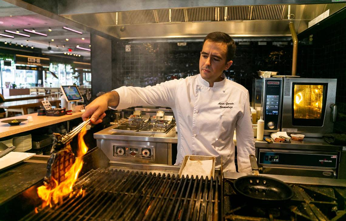 Chef Aitor Garate Berasaluze prepares a boneless ribeye steak at his Basque restaurant Lur in Time Out Market Miami in Miami Beach.