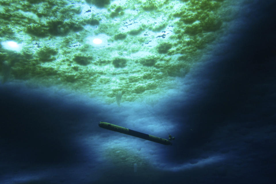 A robot nicknamed Icefin operates under the sea ice near McMurdo Station in Antarctica in 2020. The pencil-shaped robot is giving scientists their first look at the forces eating away at the Thwaites glacier. Two studies published Wednesday, Feb. 15, 2023, show the rate of melting isn't as fast as feared, but fracturing is taking the heaviest toll on the glacier. (Schmidt/Lawrence/Icefin/NASA PSTAR RISE UP via AP)