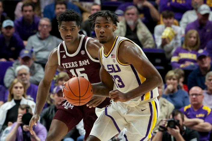Jan 26, 2022; Baton Rouge, Louisiana, USA;  LSU Tigers forward Tari Eason (13) brings the ball up court against Texas A&amp;M Aggies forward Henry Coleman III (15) during the first half at the Pete Maravich Assembly Center. Mandatory Credit: Stephen Lew-USA TODAY Sports