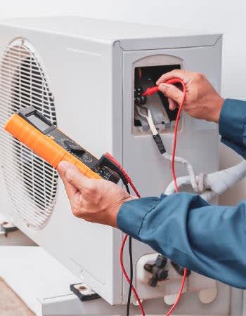 A close up of someone using a multimeter.