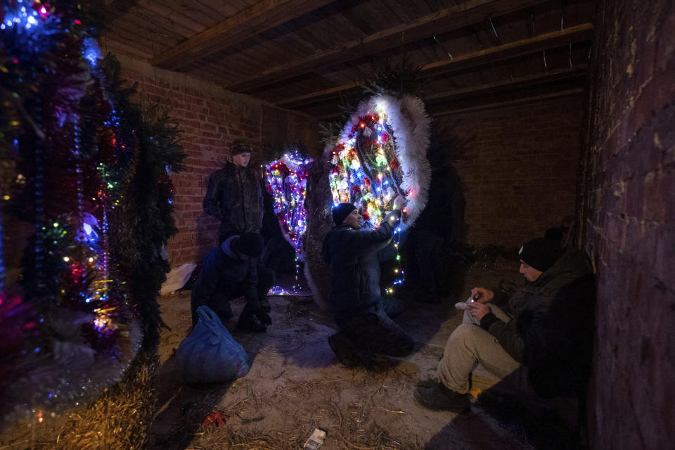 Villagers decorate bear costumes in preparation for the Malanka festival in the village of Krasnoilsk, Ukraine, Wednesday, Jan. 12, 2022. (AP Photo/Ethan Swope)