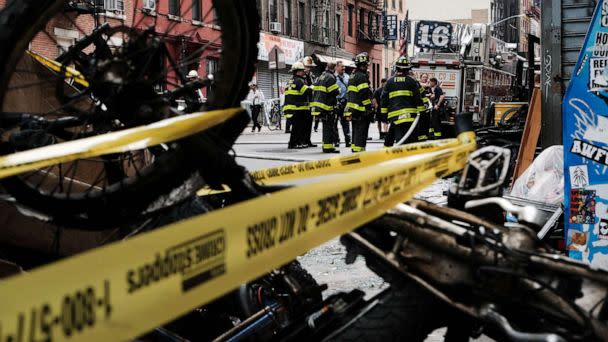 PHOTO: Charred remains of e-bikes and scooters sit outside of a building in Chinatown after four people were killed by a fire in an e-bike repair shop overnight, June 20, 2023 in New York City. (Spencer Platt/Getty Images)