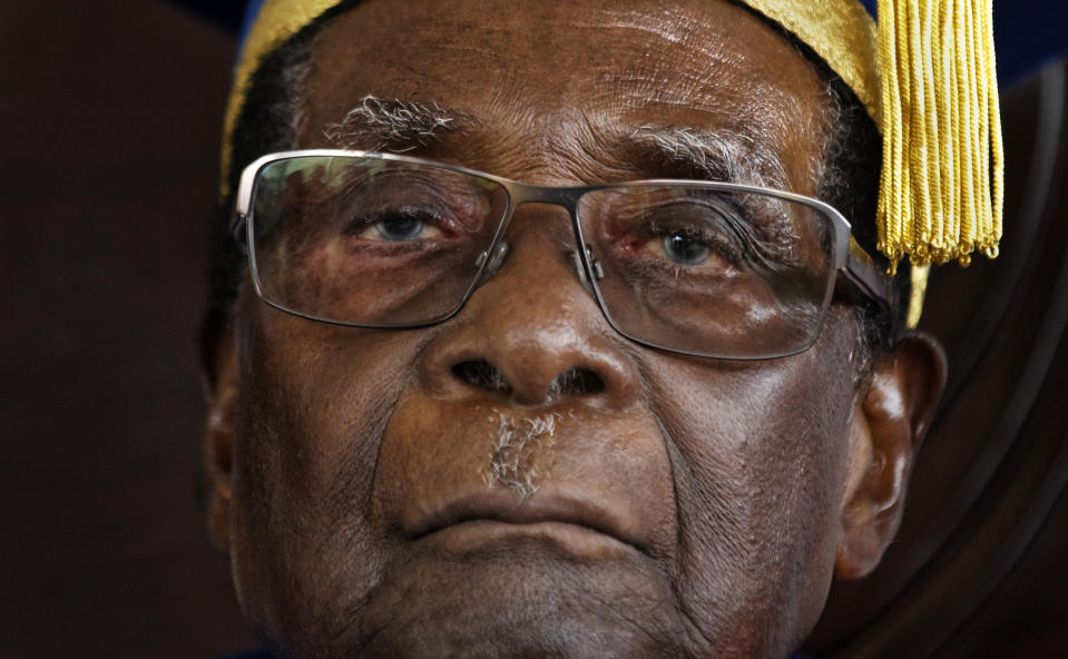 FILE -- In this Friday, Nov. 17, 2017 file photo, Zimbabwe's President Robert Mugabe officiates at a student graduation ceremony at Zimbabwe Open University on the outskirts of Harare, Zimbabwe. On Friday, Sept. 6, 2019, Zimbabwe President Emmerson Mnangagwa said his predecessor Robert Mugabe, age 95, has died. (AP Photo/Ben Curtis, File)