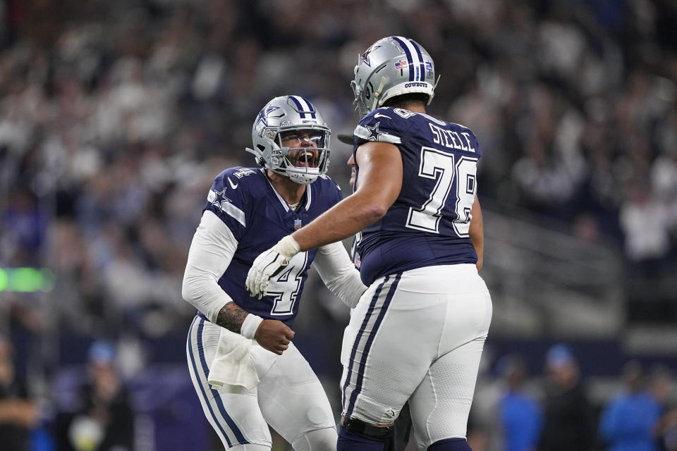 Dallas Cowboys quarterback Dak Prescott (4) reacts with offensive tackle Terence Steele (78) after throwing a touchdown pass against the Detroit Lions during the second half of an NFL football game, Saturday, Dec. 30, 2023, in Arlington, Texas. (AP Photo/Sam Hodde)