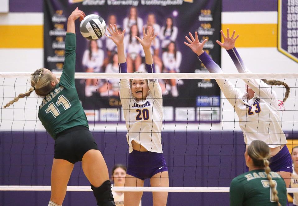 McKenna Weber, 20, and Kaylee Evans, 23, of Jackson defend against the kill attempt Lydia Ayers, 11, of GlenOak during their game at Jackson on Tuesday, Oct. 11, 2022.