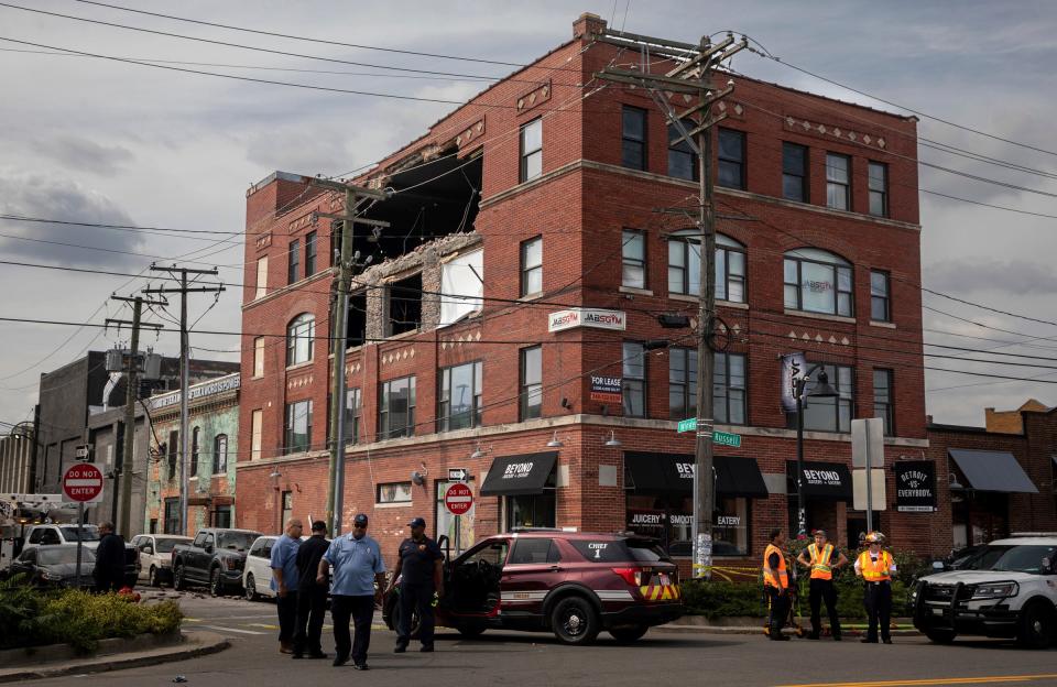 Detroit Fire Department personnel converge on the scene where a gaping hole is left following a partial collapse on the second floor of a building known as the Del Bene building at the corner of Winder and Russell in Detroit, across from Eastern Market on Saturday, Sept. 16, 2023.