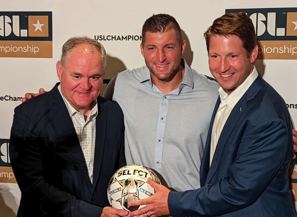 JAXUSL's Steve Livingstone, Tim Tebow and Ricky Caplin hold a soccer ball after  a press conference announcing that Jacksonville's JAXUSL group is receiving a franchise in the United Soccer League Championship on August 30, 2022. [Clayton Freeman/Florida Times-Union]