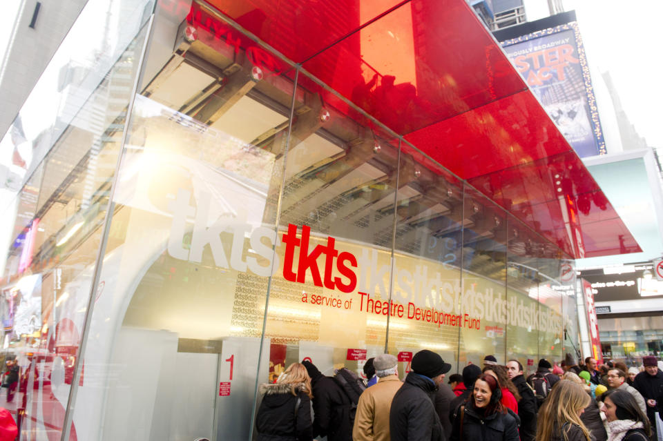 FILE - People wait in line at the Times Square TKTS discount ticket booth in New York on Jan. 19, 2012. The TKTS booth in Times Square, which has become part of the city's visual and financial DNA and a key part in keeping Broadway going, celebrates its 50th birthday this week. (AP Photo/Charles Sykes, File)