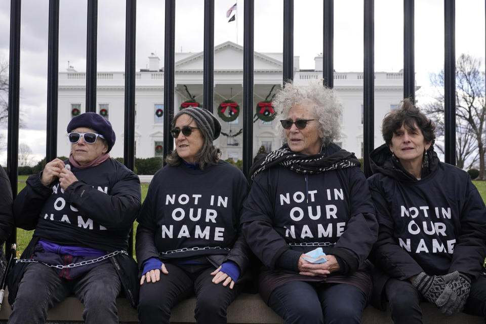 Activists with Jewish Voice for Peace, gather to protest the Israel-Hamas war in Gaza and chain themselves to the fence outside the White House, Monday, Dec. 11, 2023, in Washington. (AP Photo/Susan Walsh)