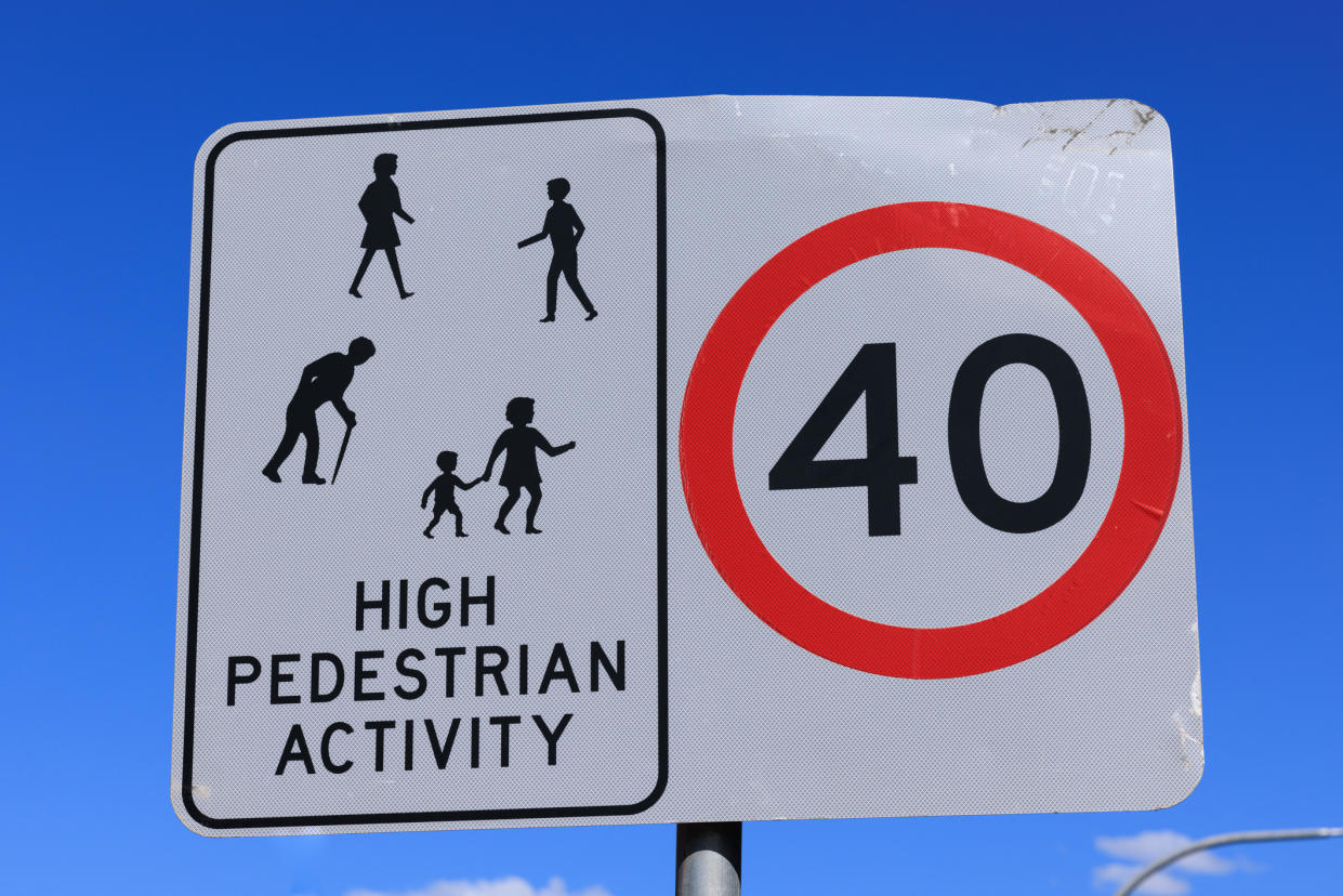 40km/h sign for speed limit and warning drivers to be aware of people.