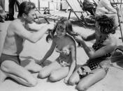 <p>Kirk Douglas braids Brigitte Bardot's hair at the Cannes Film Festival in 1953. </p>