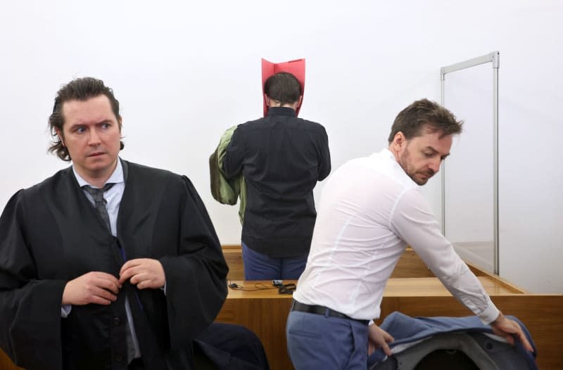 The US defendant stands behind his lawyers Philip Mueller (L) and Alexander Stevens at the regional court in Kempten. A 31-year-old US citizen has received a lifelong prison sentence for murder, attempted murder and rape after attacking two women near southern Germany's famed Neuschwanstein Castle last year, the court announced on Monday. Karl-Josef Hildenbrand/dpa