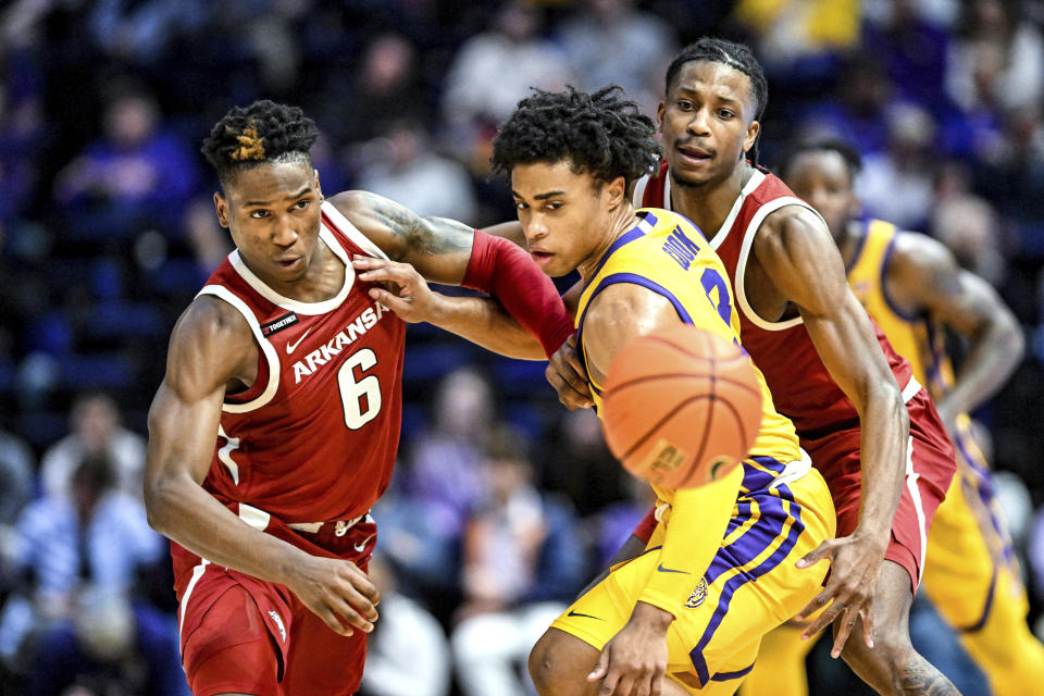 Arkansas guard Layden Blocker (6) and LSU guard Jalen Cook (3) battle for a loose ball during an NCAA college basketball game at Pete Maravich Assembly Center, Saturday, Feb. 3, 2024, Baton Rouge, La. (Javier Gallegos/The Advocate via AP)