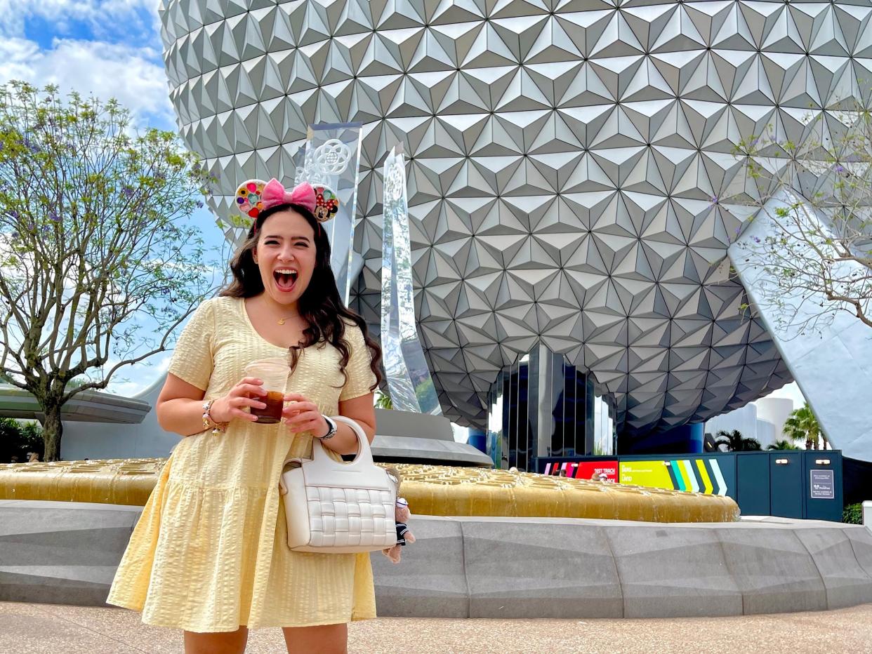 photo of josie posing with the spaceship earth ball at epcot