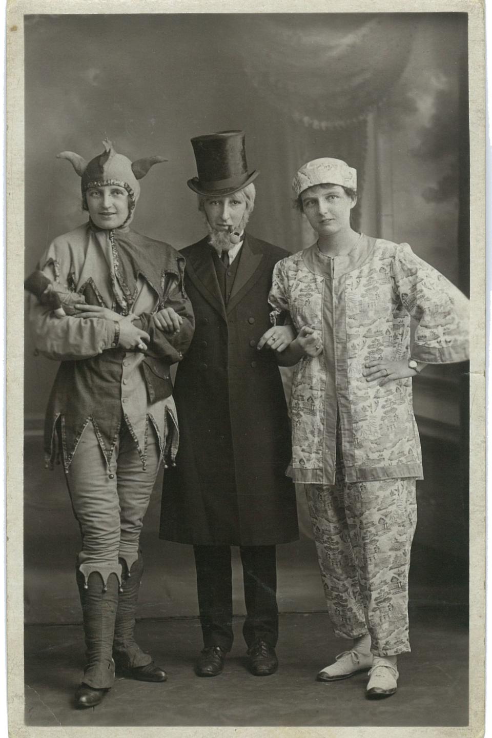 <p>Three performers dressed up circa 1900.</p>