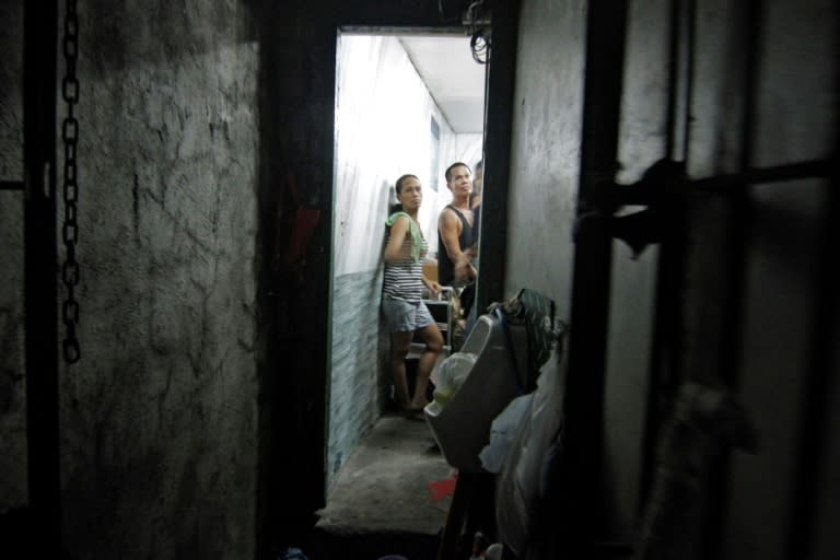 A dozen people have been found stuffed inside a closet-sized cell hidden behind a book shelf in a Philippine police station