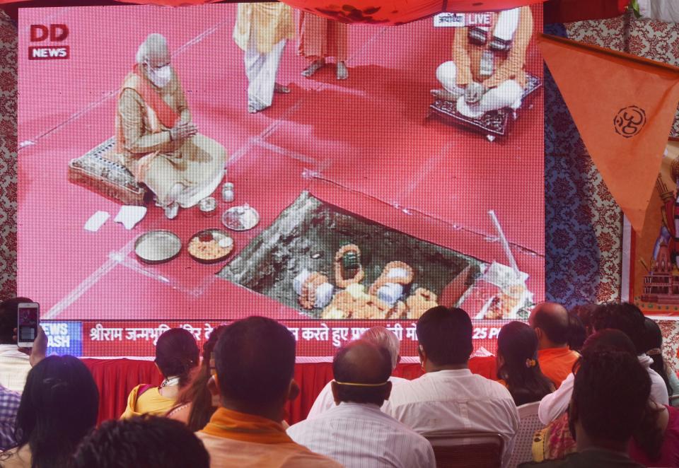 NEW DELHI, INDIA - AUGUST 5:   Devotees watch Narendra Modi perform Bhoomi Pujan for the construction of Ram Temple in Ayodhyatelecasted live at VHP Office at RK Puram on August 5, 2020 in New Delhi, India. The grand celebrations for the bhoomi pujan started at 8 am and Prime Minister Narendra Modi performed the Ayodhya Ram Mandir bhoomi pujan at the auspicious time of 12:40 pm.  (Photo by Vipin Kumar/Hindustan Times via Getty Images)