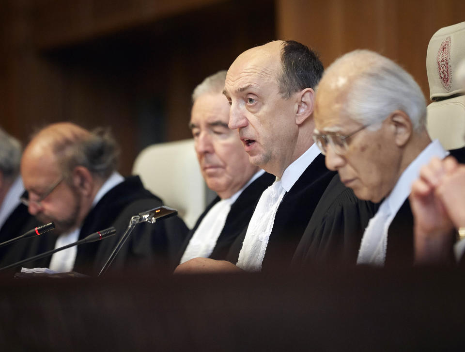 Judge Peter Tomka, center, president of the International Court of Justice, delivers its verdict in The Hague, Netherlands, Monday March 31, 2014. The International Court of Justice is ruling Monday on Australia's challenge against Japan for whaling in Antarctic waters. (AP Photo/Phil Nijhuis)