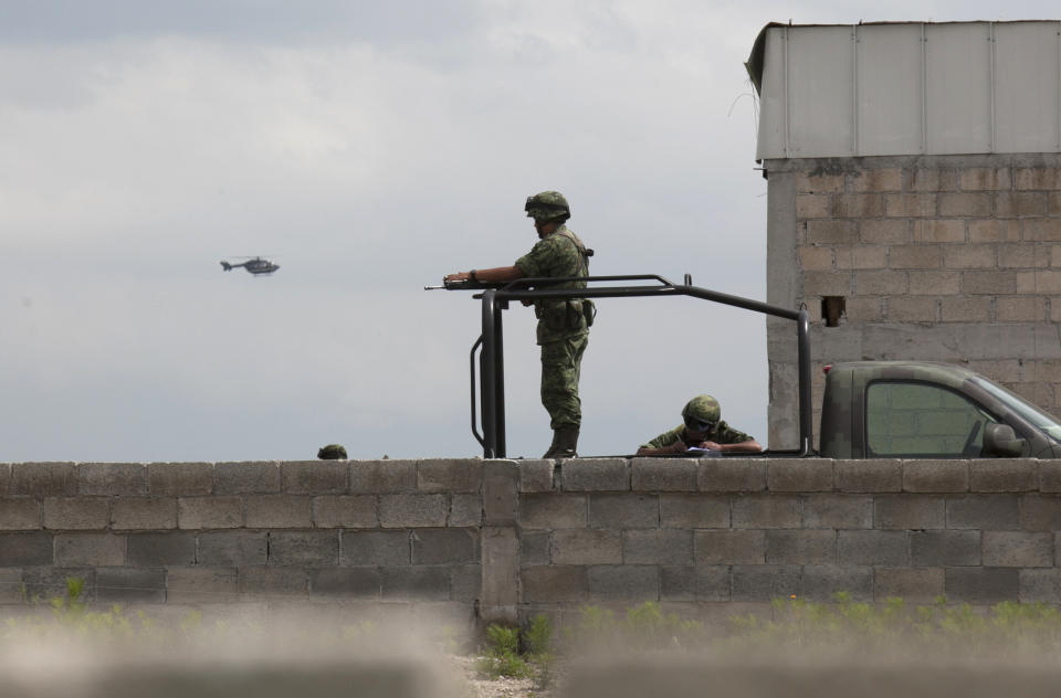 Soldiers guard a half-built house near the Altiplano maximum security prison in Almoloya, west of Mexico City, Sunday, July 12, 2015. (AP Photo/Marco Ugarte)