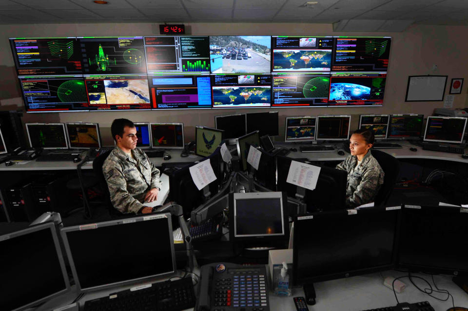 Staff Sgt. Alex Garviria and 2nd Lt. Rachel James work in the Global Strategic Warning and Space Surveillance System Center Sept. 2, 2014, at Cheyenne Mountain Air Force Station, Colo. Garviria is a 721st CS senior systems controller and James is the 721s (Alamy Stock Photo)