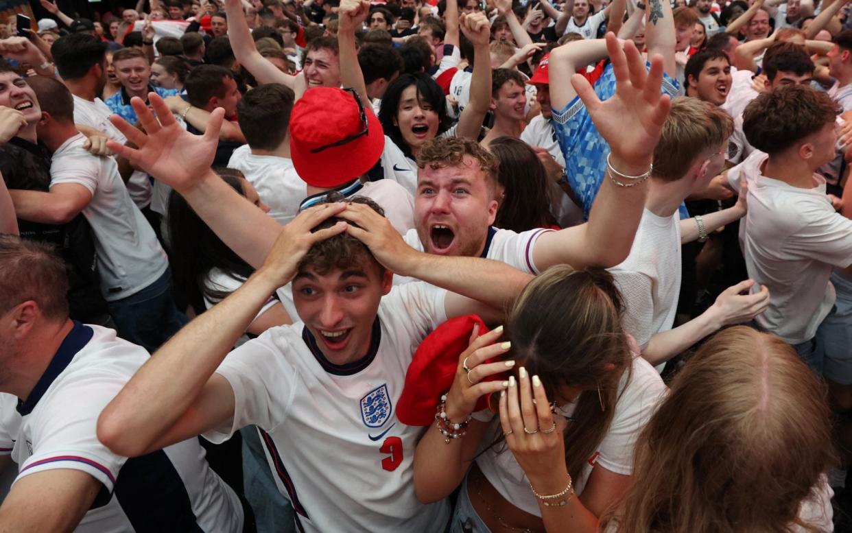 Fans gather for England v Slovakia - London, Britain - June 30, 2024 England fans celebrate after Jude Bellingham scores their first goal as they watch the match at BoxPark Wembley