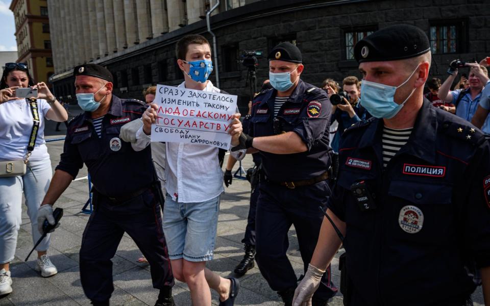 Police officers detain a supporter of Ivan Safronov - AFP