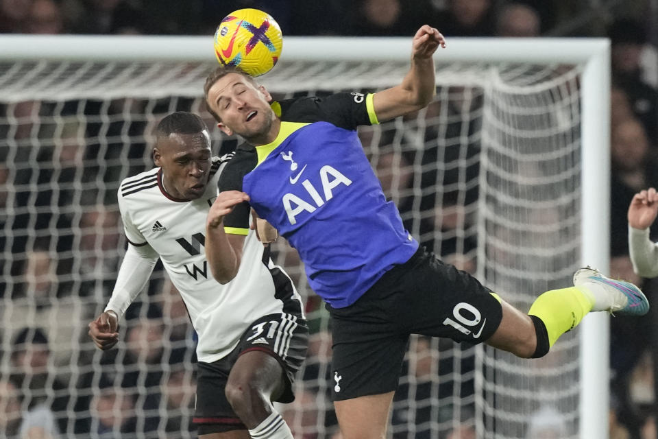 Tottenham's Harry Kane jumps for a header with Fulham's Issa Diop, rear, during the English Premier League soccer match between Fulham and Tottenham Hotspur at the Craven Cottage Stadium in London, Monday, Jan. 23, 2023. (AP Photo/Frank Augstein)