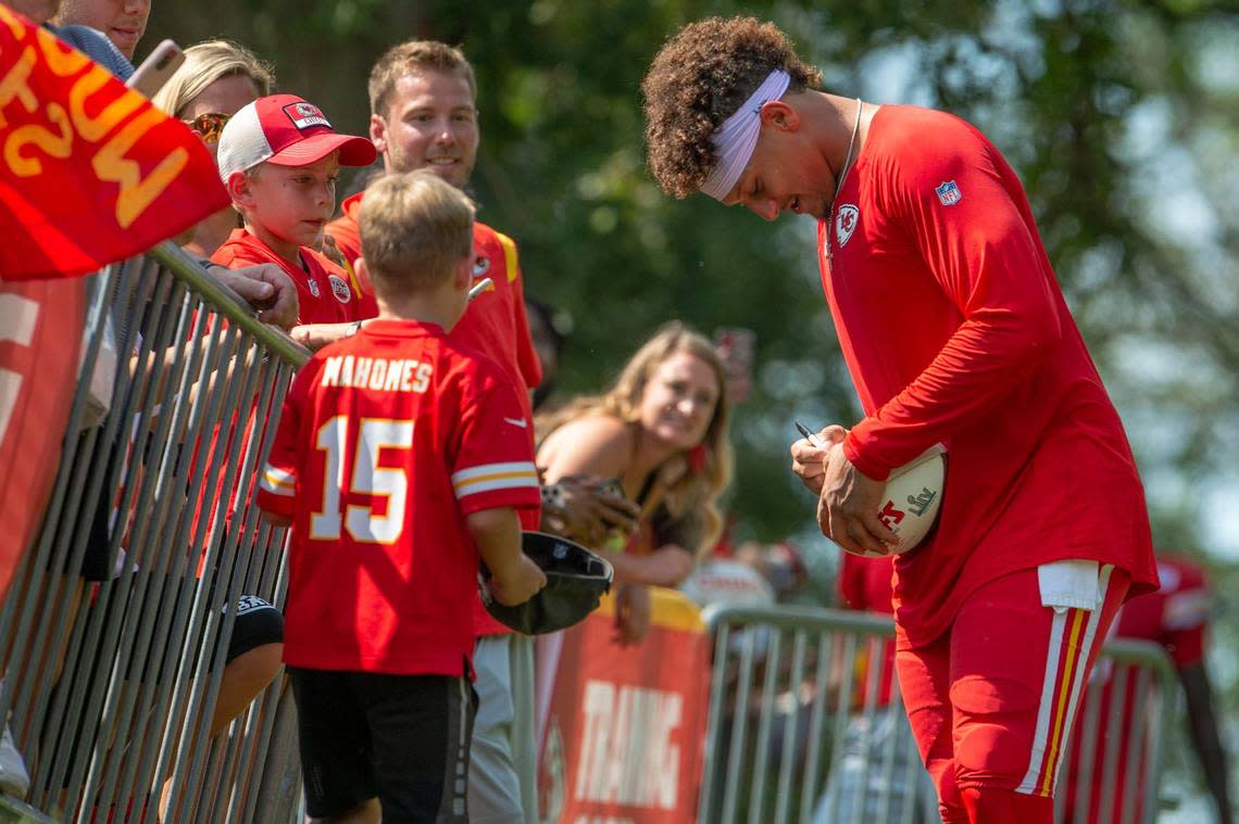 Kansas City Chiefs quarterback Partick Mahomes (15) signs autographs for fans after the first padded practice at Chiefs training camp on Monday, Aug., 1 2022, in St. Joseph.