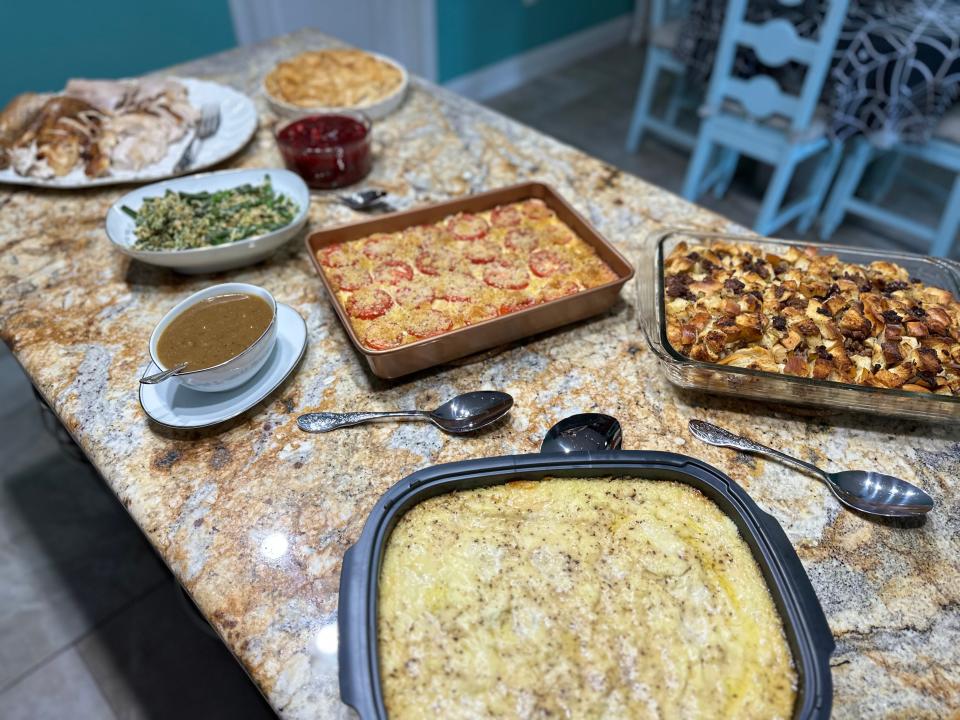 Thanksgiving dinner including turkey, mashed potatoes, and stuffing, spread out on a countertop