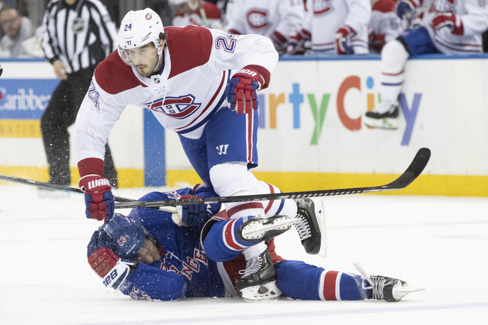 Montreal Canadiens center Phillip Danault (24) trips over New York Rangers defenseman Adam Fox (23) during the second period of an NHL hockey game Friday, Dec. 6, 2019, at Madison Square Garden in New York. (AP Photo/Mary Altaffer)