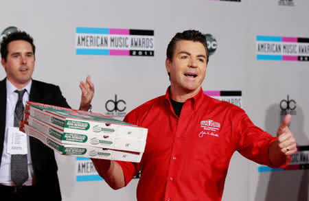 FILE PHOTO: John Schnatter (R), founder and chief executive of Papa John's Pizza, arrives at the 2011 American Music Awards in Los Angeles November 20, 2011. REUTERS/Danny Moloshok/File Photo