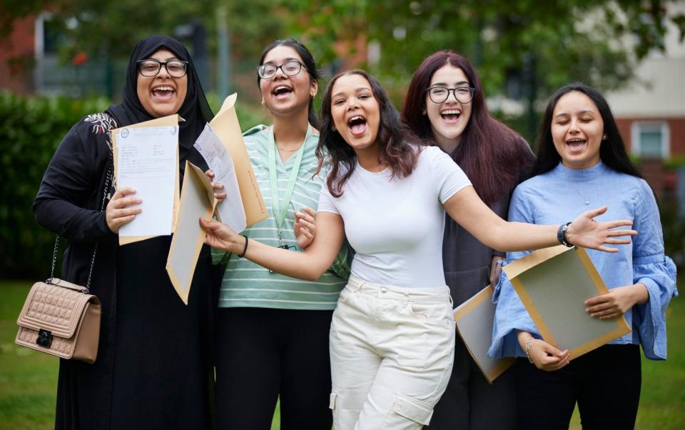 Students celebrate after receiving their A-level results. Many were left still looking for a university place on Thursday amid a scramble for slots through clearing - Mark Waugh 