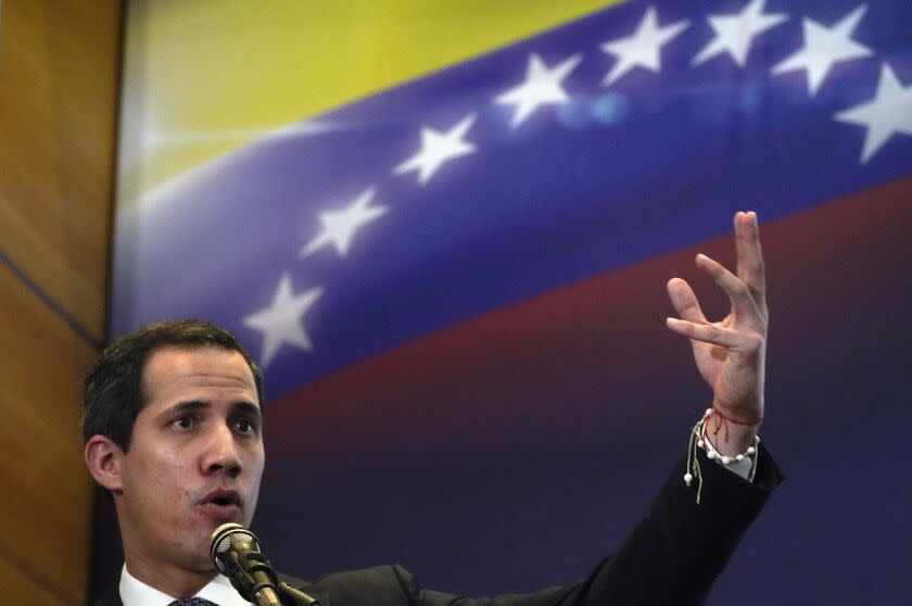 FILE - Opposition leader Juan Guaido explains the income and expenses of his self-proclaimed, parallel government in Caracas, Venezuela, Sept. 16, 2022. Guaido declared himself Venezuela's interim president in January 2019, arguing that in his capacity as then-president of the country's National Assembly the constitution allowed him to form a transitional government because Nicolas Maduro had been re-elected in a sham vote in late 2018. Dozens of countries, including the U.S., Canada and Colombia, supported Guaido's move and began recognizing him as Venezuela's legitimate leader. (AP Photo/Ariana Cubillos, File)