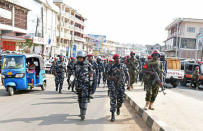 Police officers walk towards their police station in Lumley, in Freetown, Sierra Leone March 31, 2018. REUTERS/Olivia Acland