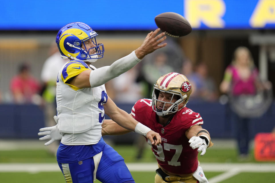 Los Angeles Rams quarterback Matthew Stafford, left, gets a pass off before San Francisco 49ers defensive end Nick Bosa hits him during the second half of an NFL football game Sunday, Sept. 17, 2023, in Inglewood, Calif. (AP Photo/Gregory Bull)