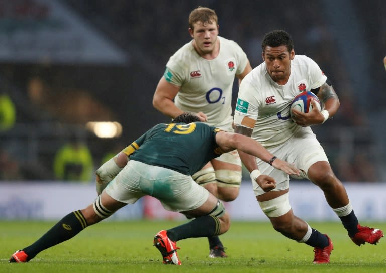 England's Nathan Hughes (R) is tackled by South Africa's Franco Mostert during a test match between England and South Africa on November 12, 2016