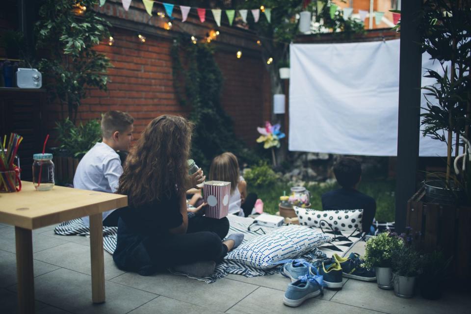 kids attend a movie night in the backyard