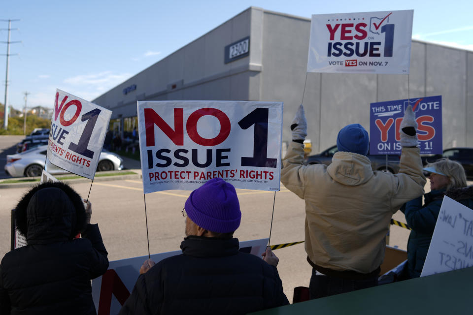 FILE - People gather in the parking lot of the Hamilton County Board of Elections as people arrive for early in-person voting, in Cincinnati, Thursday, Nov. 2, 2023. (AP Photo/Carolyn Kaster, File)