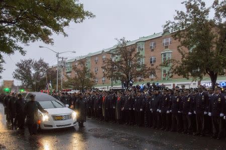 The casket of slain New York City Police (NYPD) officer Randolph Holder is carried by a hearse following his funeral service at the Greater Allen A.M.E. Cathedral of New York in the Queens borough of New York City, October 28, 2015. REUTERS/Brendan McDermid