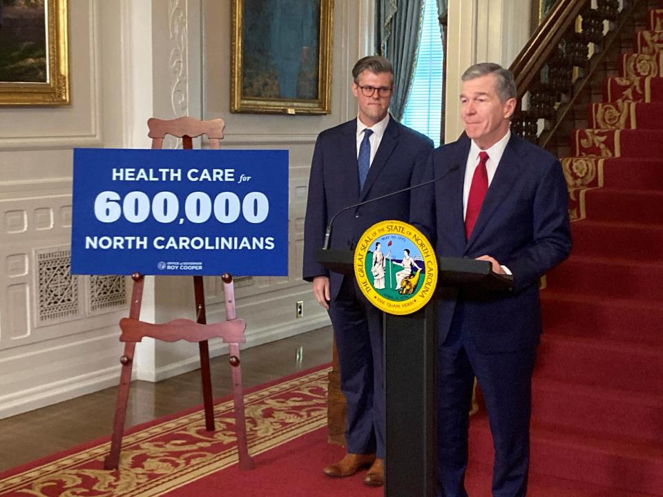 North Carolina Gov. Roy Cooper, right, speaks while state Health and Human Services Secretary Kody Kinsley listens at an Executive Mansion news conference in Raleigh on Monday, Sept. 25, 2023. Cooper and Kinsley announced that North Carolina would launch Medicaid expansion coverage on Dec. 1.