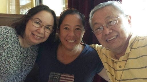 Liz Tchou (center) with her mother, Anna Tchou (left) and father John Tchou. Liz was a field hockey star at Shawnee High School and was an All-American at the University of Iowa and a member of the 1996 U.S. Olympic field hockey team. She currently is the senior manager of coach education for USA Field Hockey.