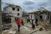 A day after a rocket struck homes in Zaporizhzhia for the first time, dozens of people turn up to help clear the debris and help rebuild in an outpouring of solidarity (AFP/Ed JONES)