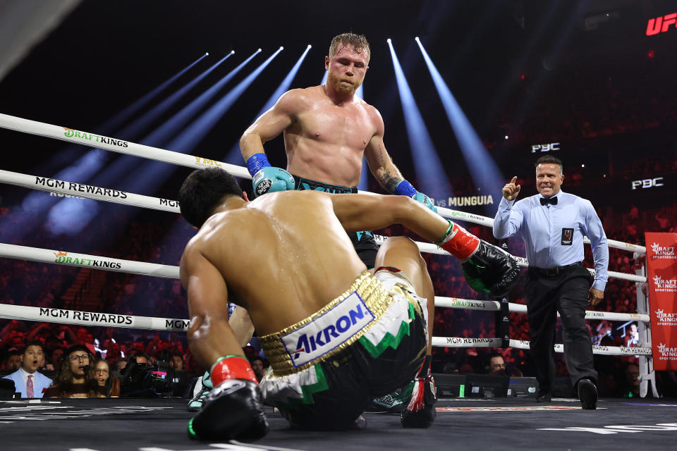 Canelo Alvarez knocks down Jaime Munguia in their super middleweight championship title fight at T-Mobile Arena on Saturday in Las Vegas. (Photo by Christian Petersen/Getty Images)