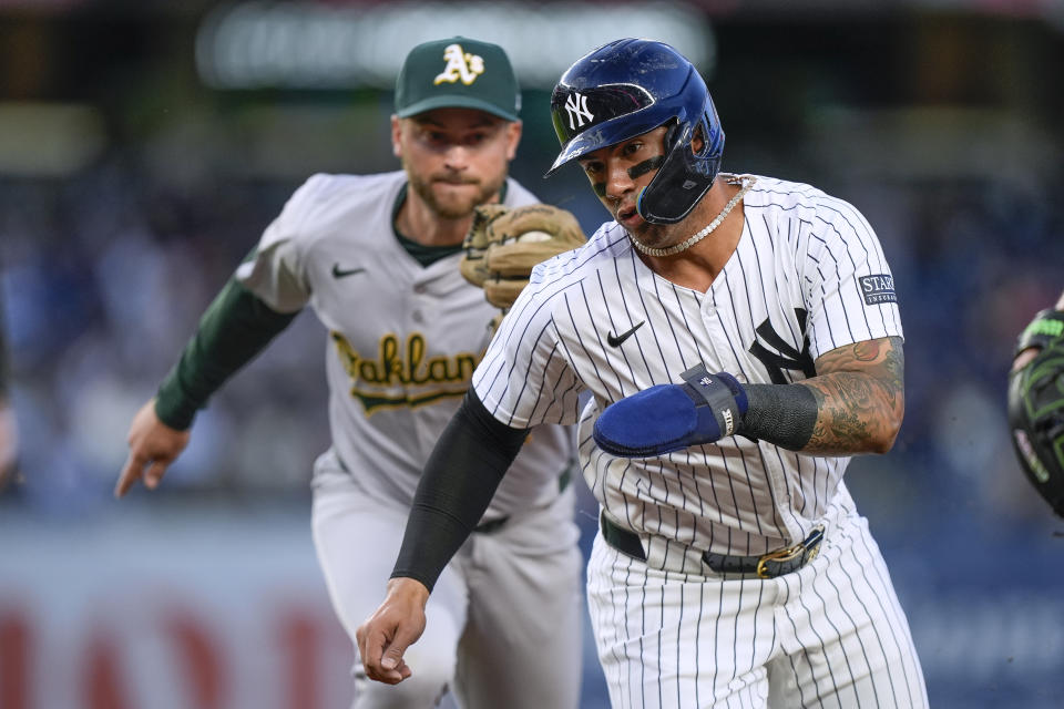 New York Yankees' Gleyber Torres is caught in a rundown and tagged out by Oakland Athletics second baseman Max Schuemann during the second inning of a baseball game Thursday, April 25, 2024, in New York. (AP Photo/Bryan Woolston)