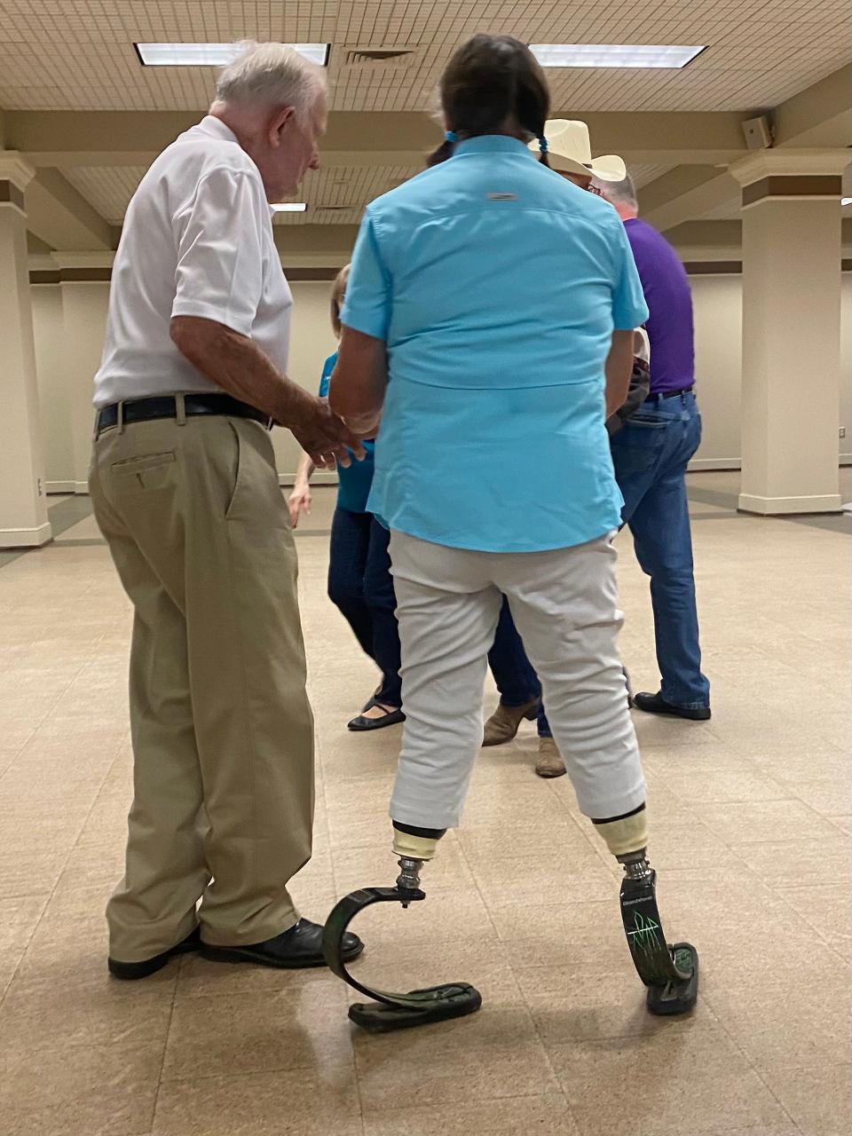 Priscilla Newton, on her prosthetic blades, takes part in a recent square dancing event at Gadsden's Downtown Civic Center.