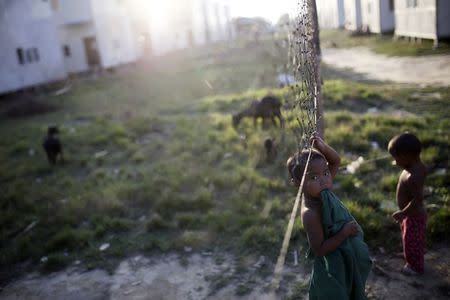 A Rakhine internally displaced girl plays in Kin Chaung village which was rebuilt after being burned by the Rohingyas in 2012 in Maungdaw town in northern Rakhine State November 9, 2014. REUTERS/Minzayar