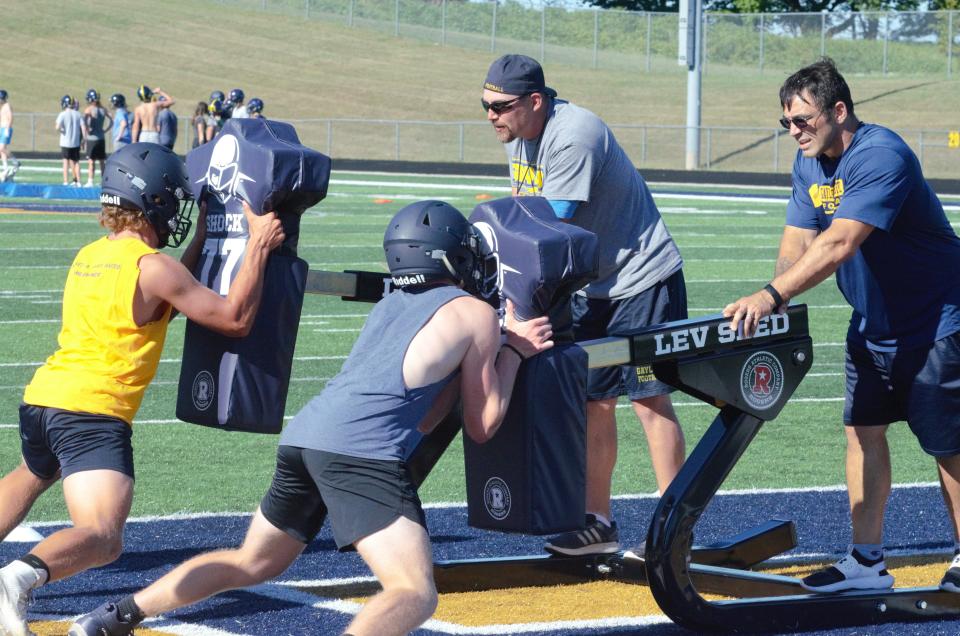 Gaylord's linemen attack a blocking sled during a practice on Tuesday, August 8.
