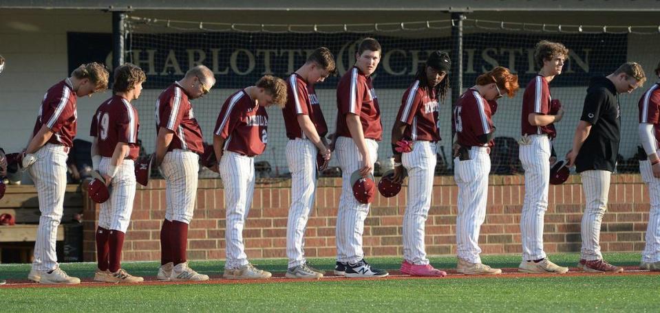 Metrolina Christian bow their heads during a pregame prayer against Charlotte Christian. Metrolina Christian lead Charlotte Christian 3-0 after four innings. The Warriors of Metrolina Christian, sporting a perfect, 19-0 record, travel edto face off against the 14-5, Charlotte Christian Knights. The teams battled on Monday, April 15, 2024.